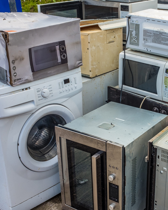 An old washing machine and a few microwaves as examples of Appliance Removal Service
